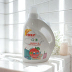 White bottle of Farlin baby clothes wash on a white tiled bathroom counter