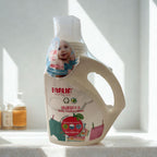 F阿拉in baby clothes wash bottle on a white surface with a blurred background